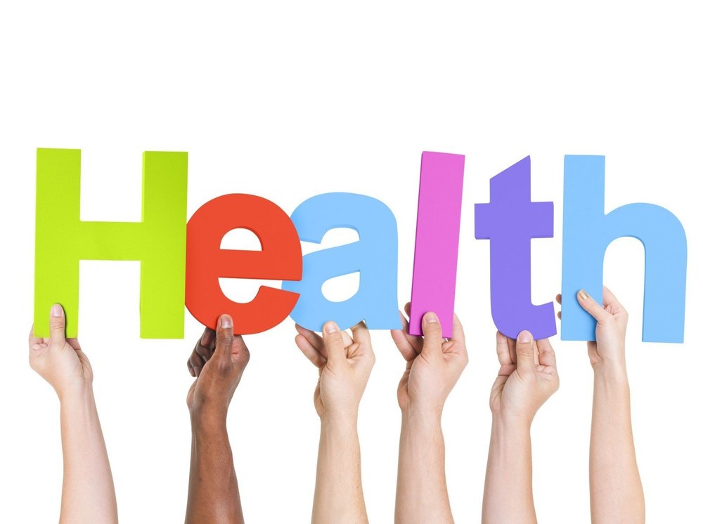 The letters that spell the word "health" each being held up by different hands.