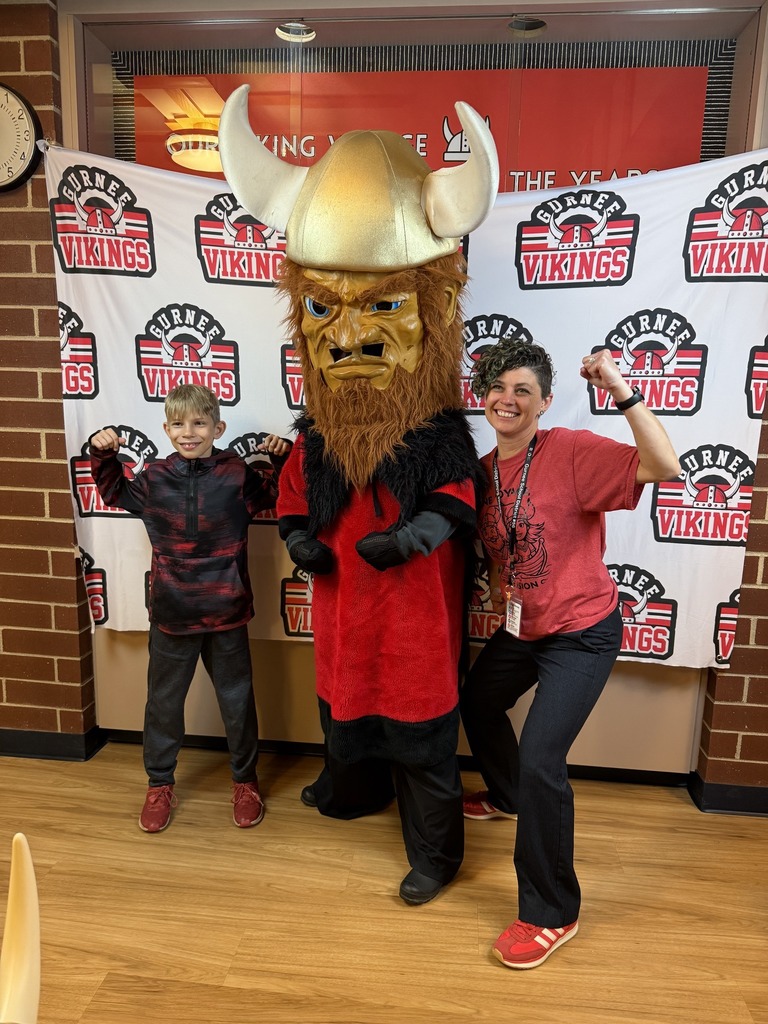 principal and student posing with viking mascot