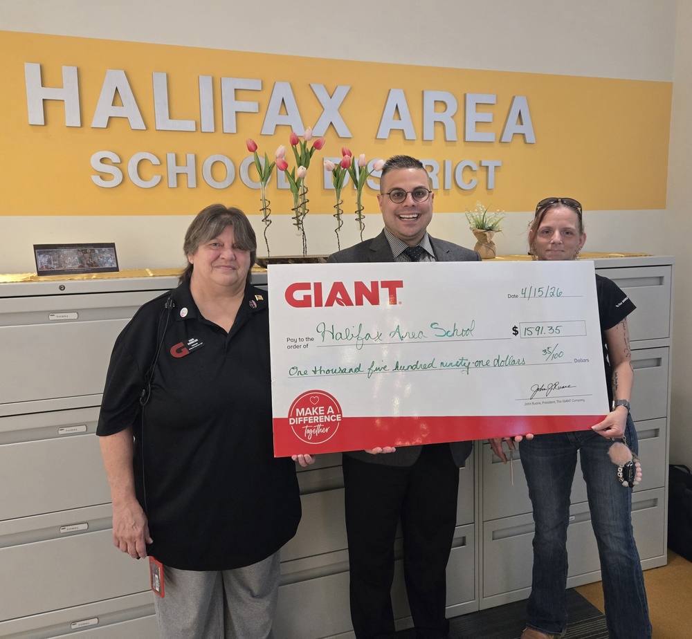 Superintendent receiving a check from Giant employees