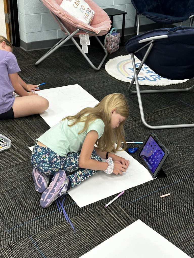 Cool Cats creating a posters to display.