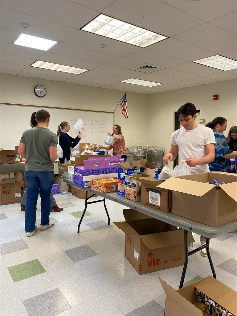 Volunteers preparing our snack packs.