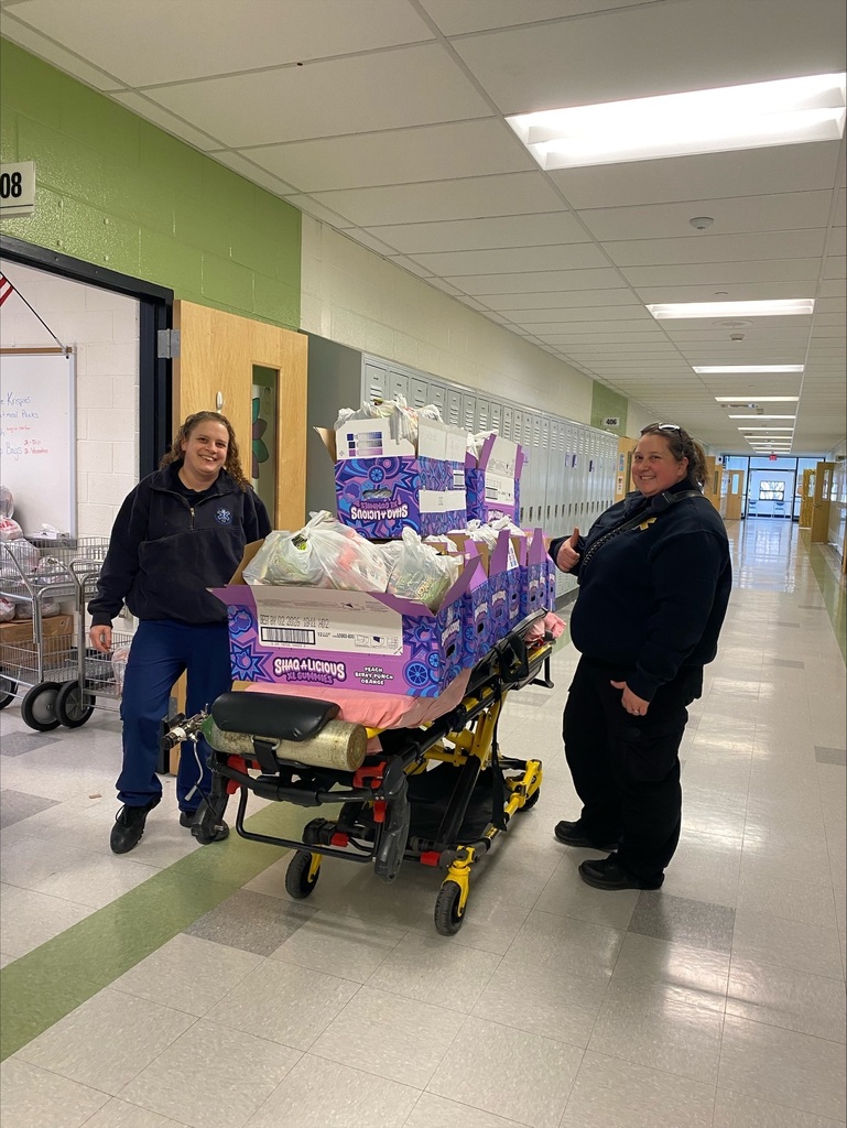 Volunteers preparing our snack packs.