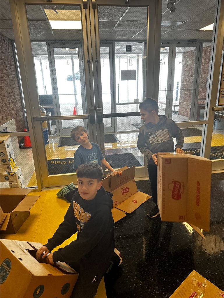 Volunteers preparing our snack packs.