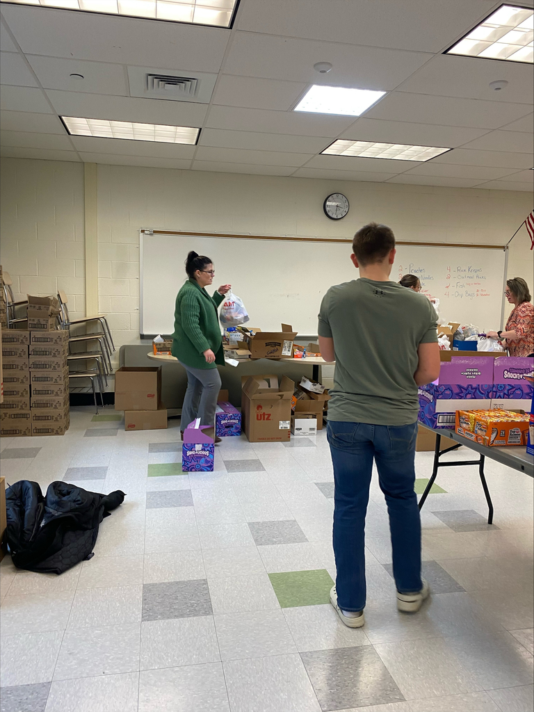 Volunteers preparing our snack packs.
