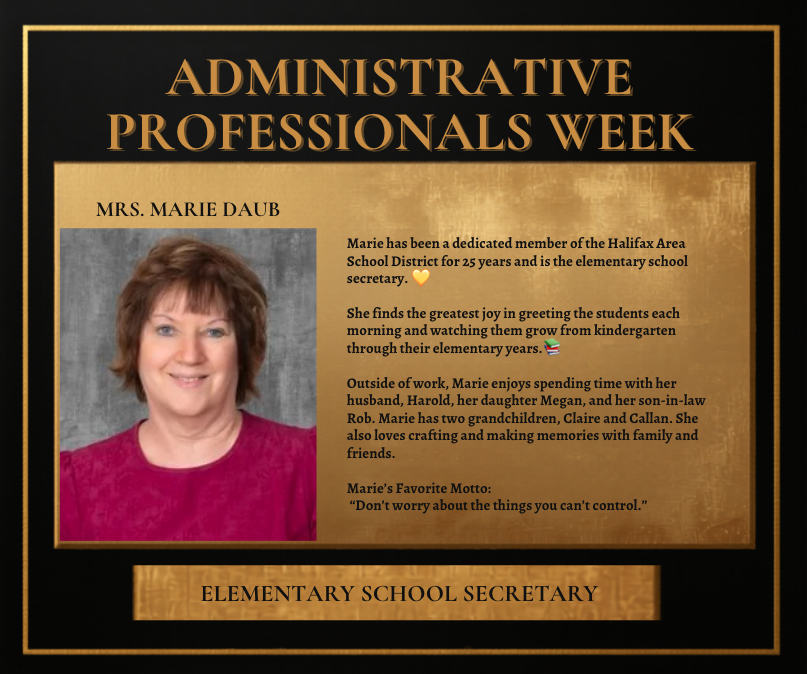 Gold plaque with text. A picture of a woman in a red shirt, short brown hair.
