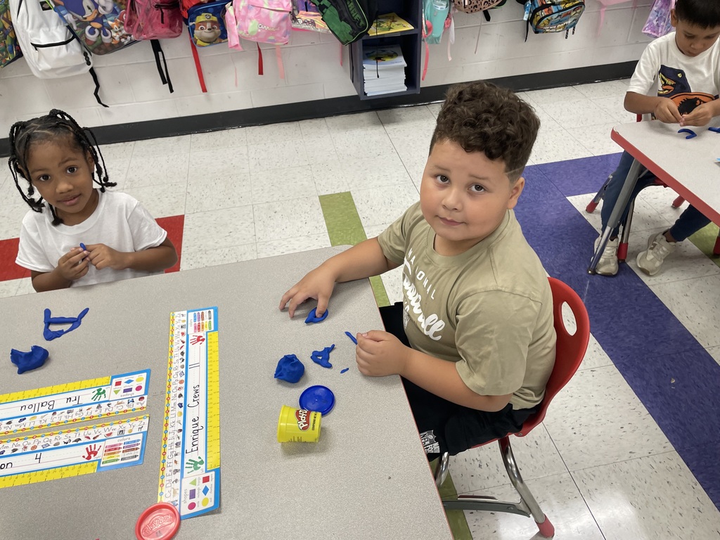 Kindergarten using Play Dough to create letters