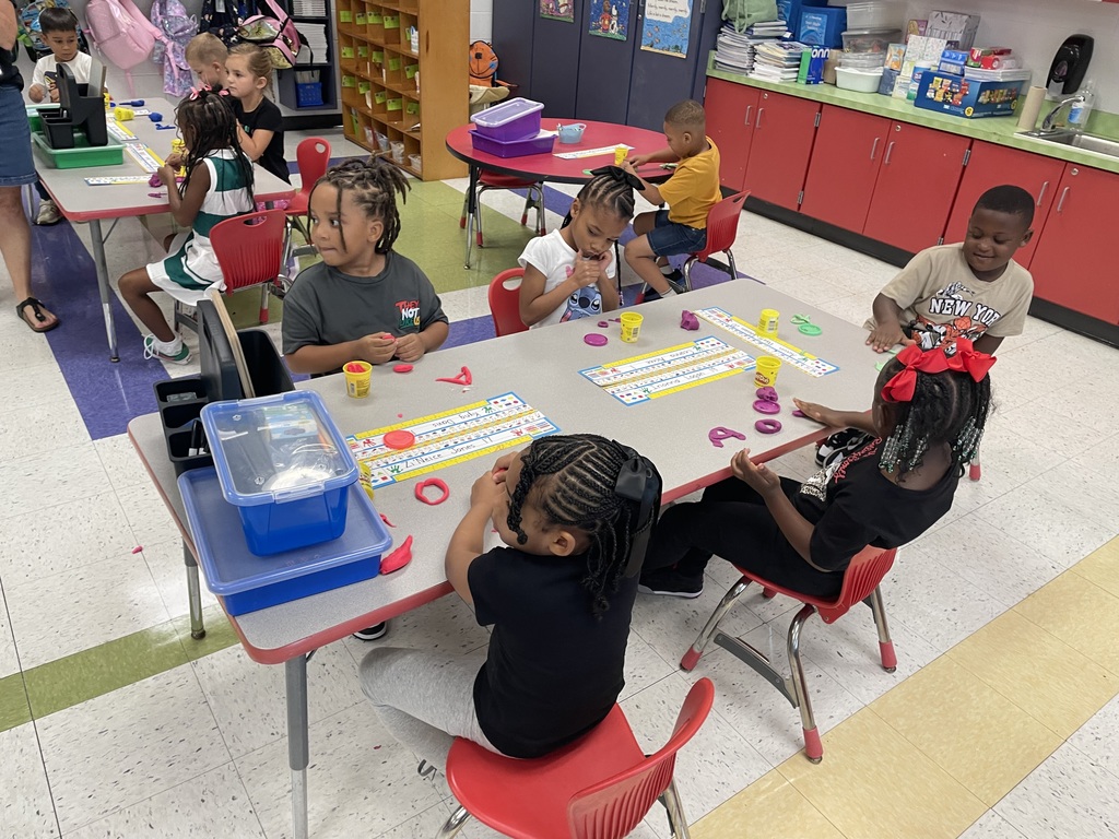 Kindergarten using Play Dough to create letters