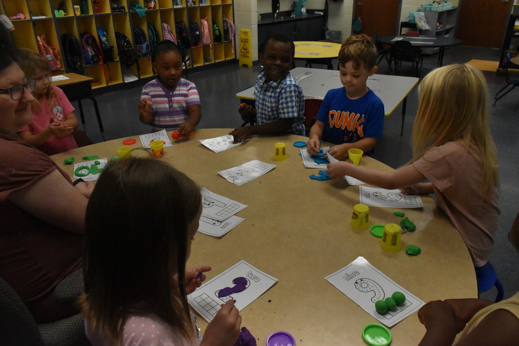 scholars working with play dough
