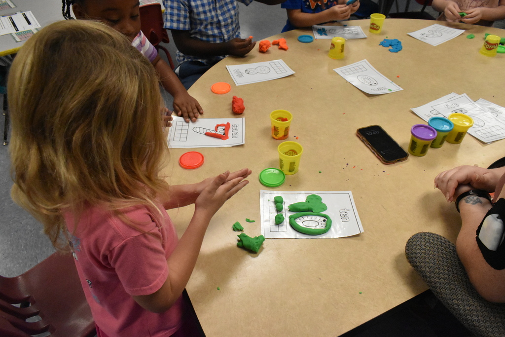 scholars working with play dough