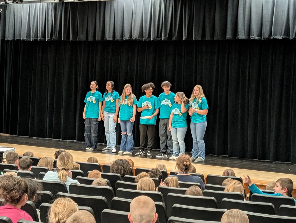 Seven students on stage