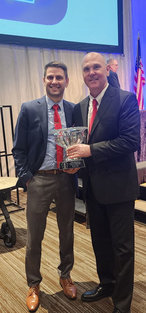 Mr. McGinley and Mr. Manapace during awards banquet for athletic director of the year