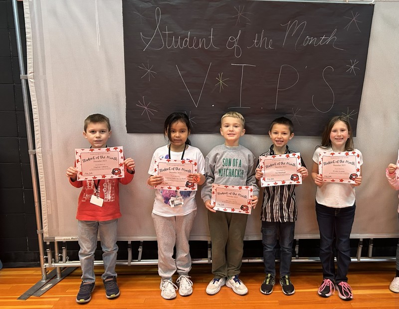 december students of the month holding certificate 