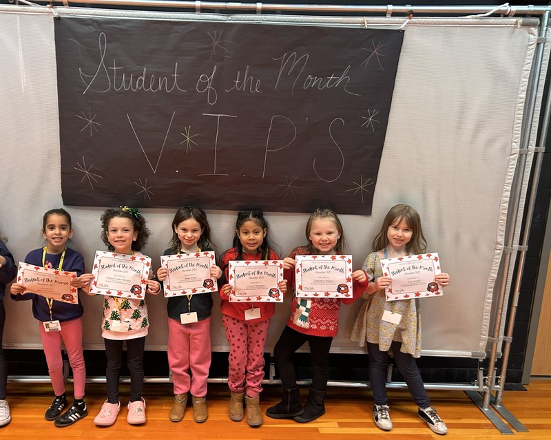 december students of the month holding certificate 