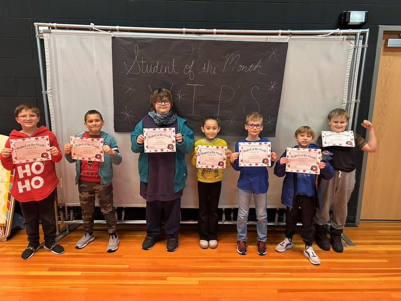 december students of the month holding certificate 