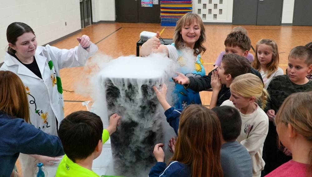 WOODTV meteorologist Ellen Bacca surrounded by students at Hamilton Elementary.