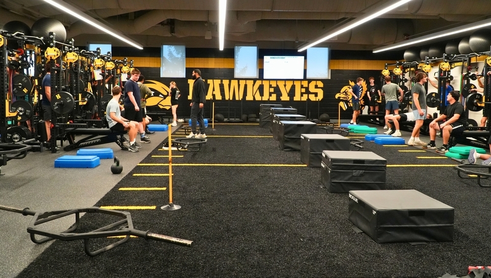 A new black and gold weight room with weight equipment.