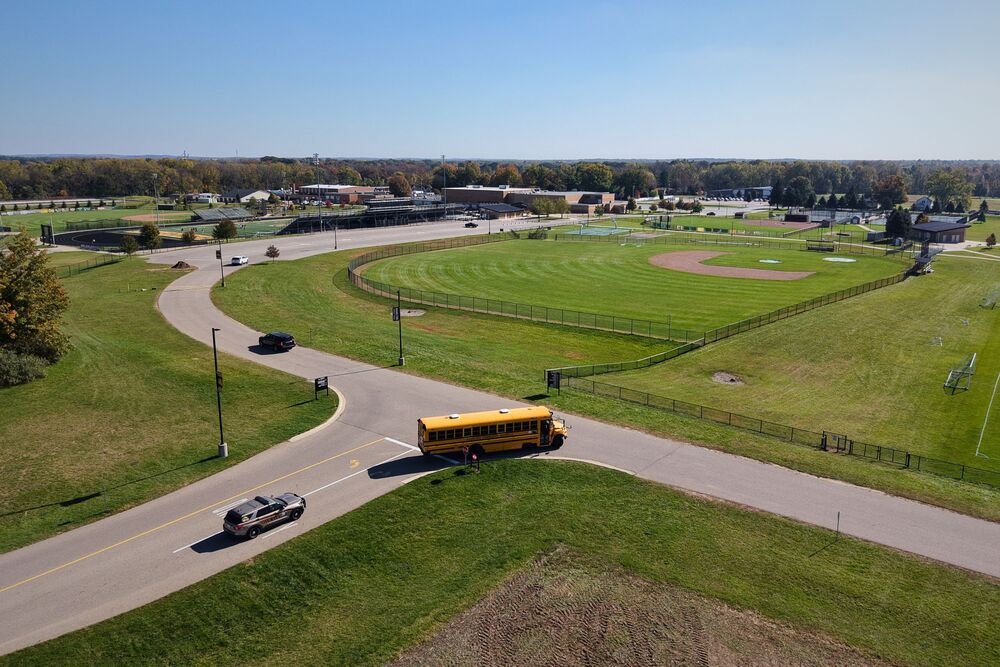 A police car follows a school bus in Hamilton.