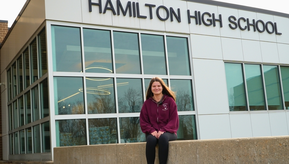 A student smiles outside of Hamilton High School.