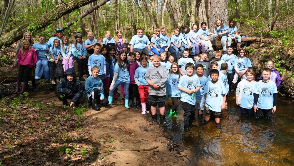 Salmon Release Day 2026 students smile in a river