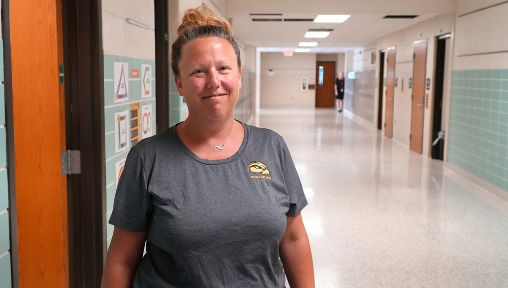 Sarah Postmus smiles in a hallway.