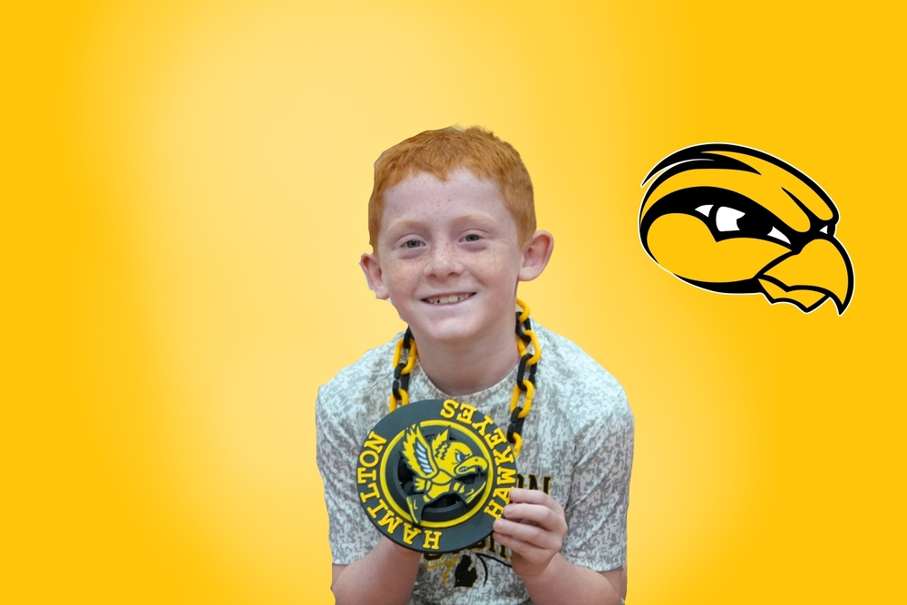 A Hamilton student smiles with a Hamiilton Hawkeyes chain.
