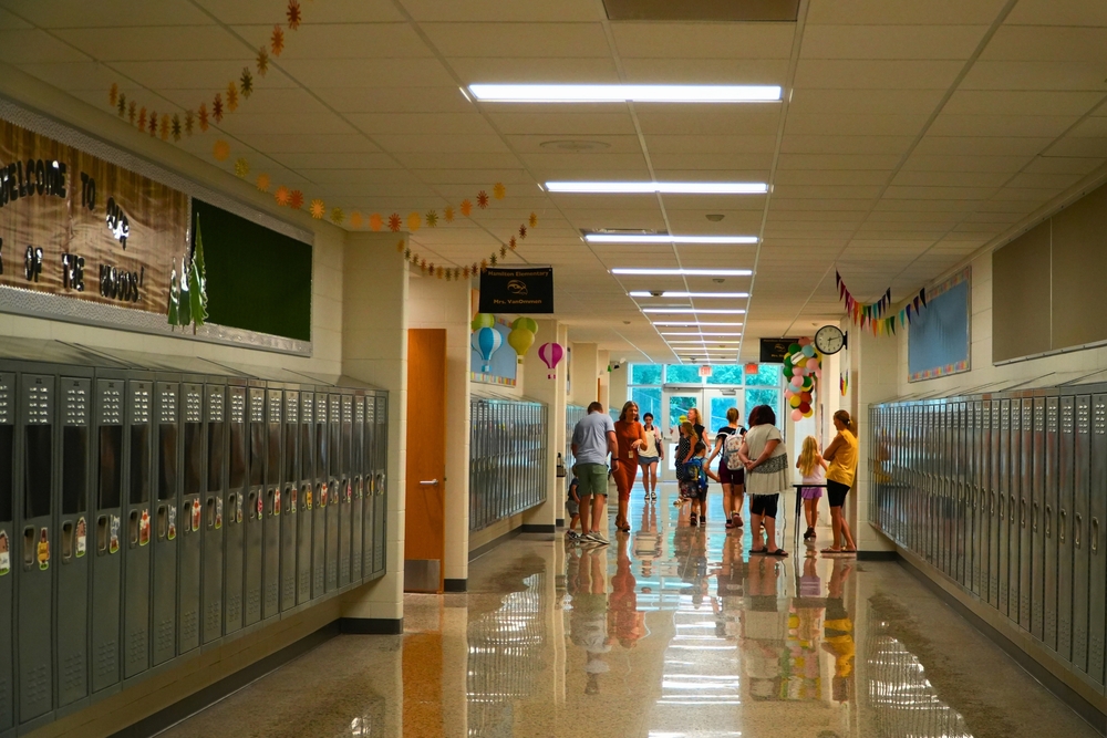 Several parents and students in a hallway.