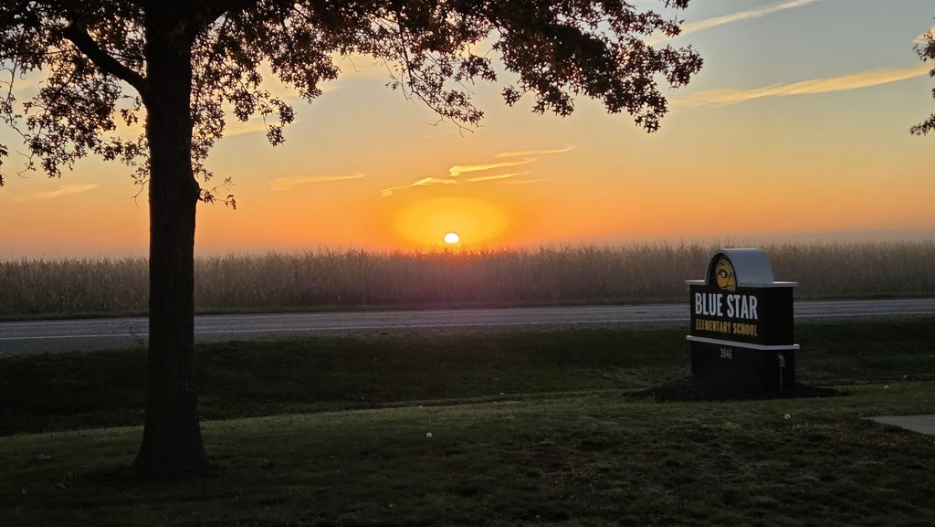 A sunrise over Blue Star Elementary and a cornfield.