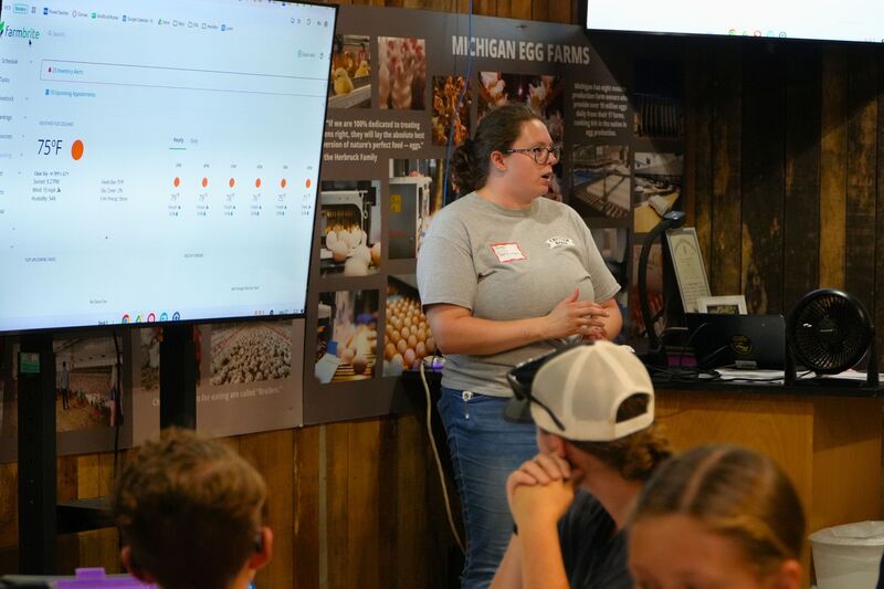 Grace VanKampen teaches in front of a class.