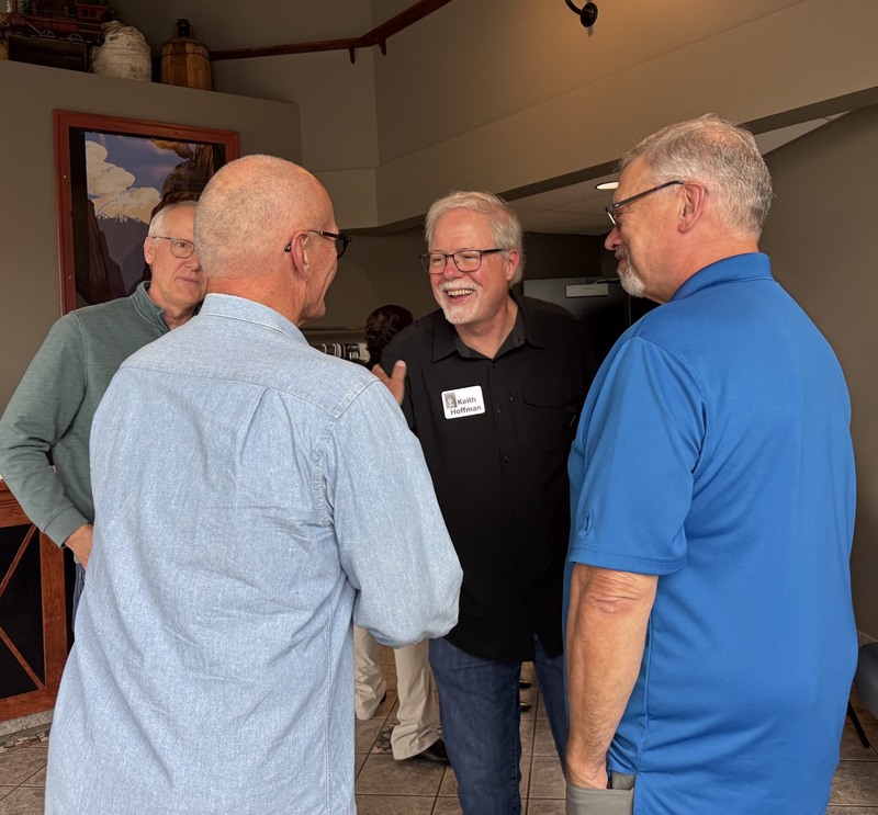 Men smile at the 50 year reunion.
