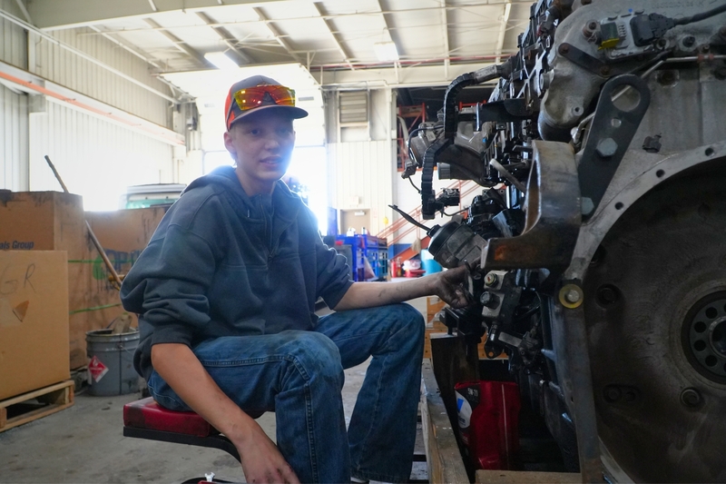 Lane works on an engine.