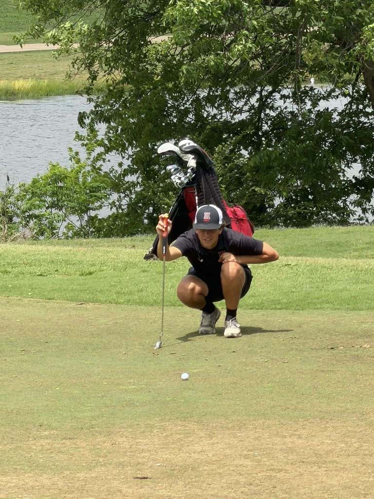 Cooper Gardner deliberates his course of action on the green