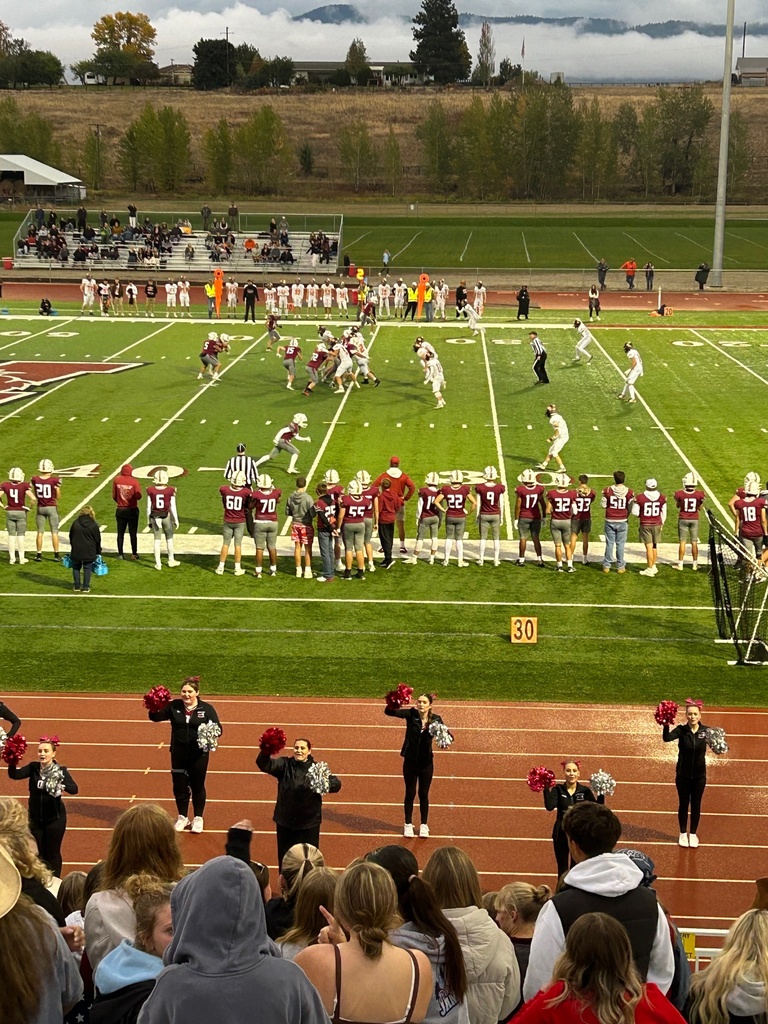 football team playing on hamilton school district football field with cheerleaders in forefront