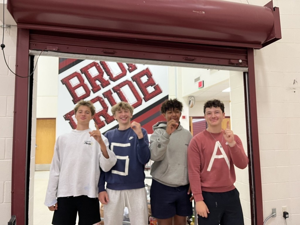 hamilton high school key club student members posing for photos in halloween costumes during their canned food drive for the local food bank