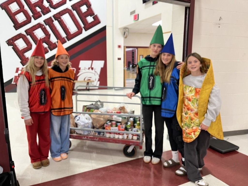 hamilton high school key club student members posing for photos in halloween costumes during their canned food drive for the local food bank