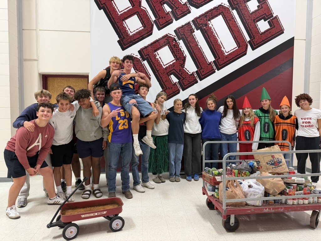 hamilton high school key club student members posing for photos in halloween costumes during their canned food drive for the local food bank