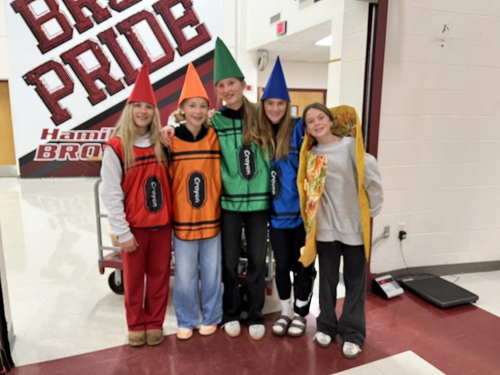 hamilton high school key club student members posing for photos in halloween costumes during their canned food drive for the local food bank