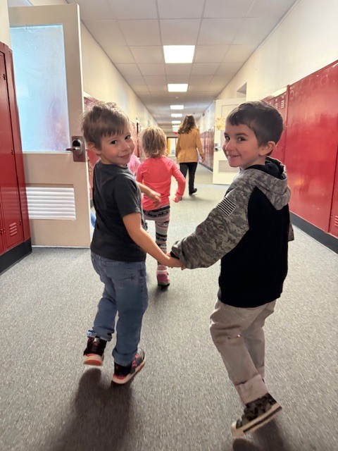 two students holding hands in the hallway at Washington Primary school