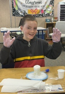 Student watches a baking soda volcano erupt!