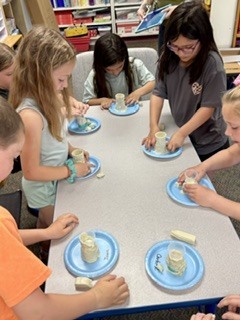 Student watches a baking soda volcano erupt!