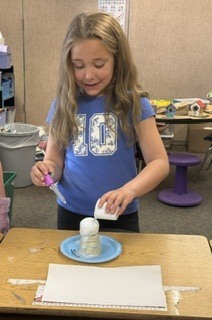 Student watches a baking soda volcano erupt!