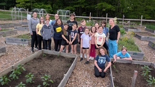 Girls on the run planting at the community garden