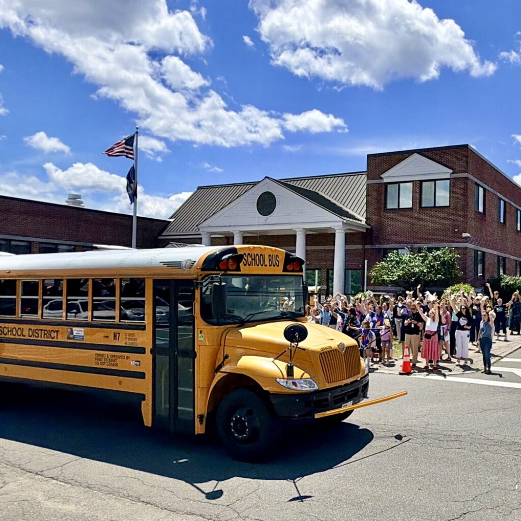 school staff waving to a 