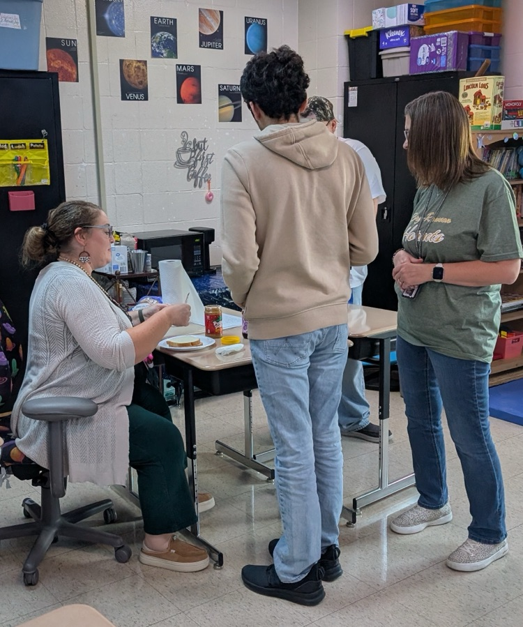 student reading directions to teacher