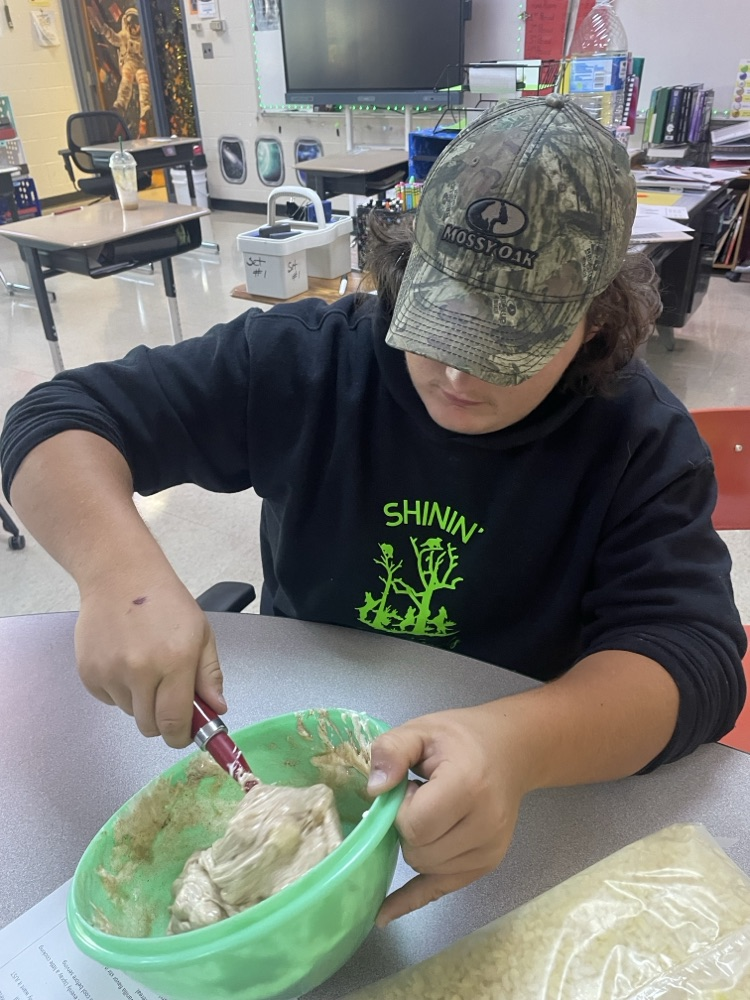 student mixing ingredients