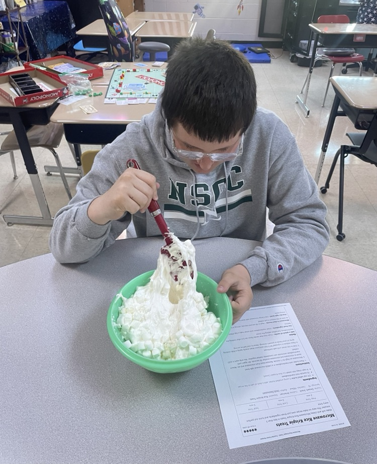 student mixing ingredients