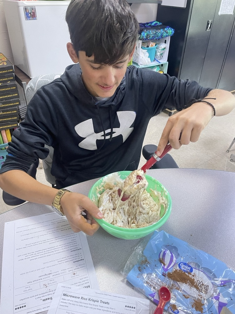 student mixing ingredients