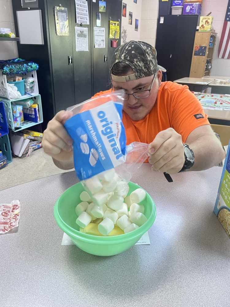 student mixing ingredients