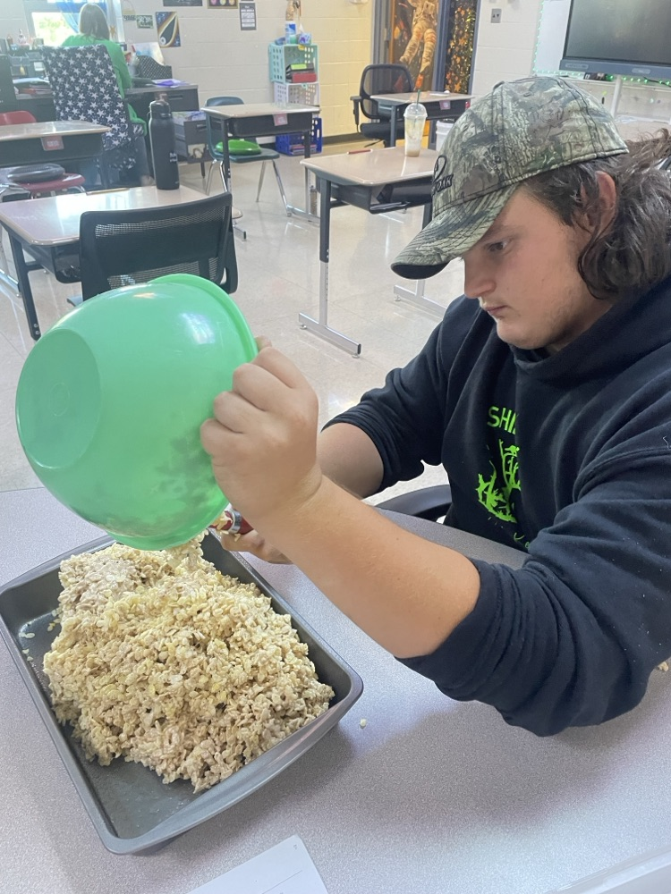 student mixing ingredients