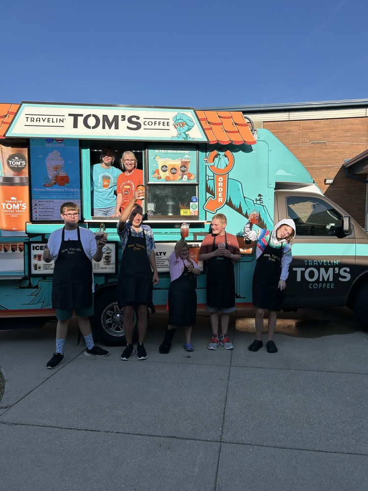students in front of truck 