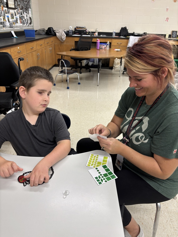 student and teacher making sun catcher